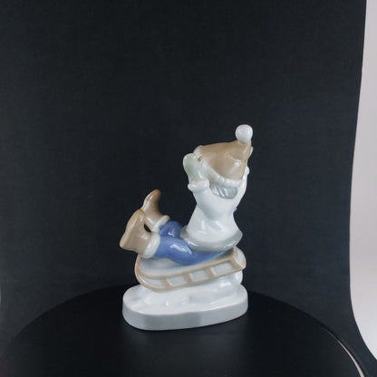 Vintage Germany-Made Porcelain Kid on Sled Figurine, Good Condition, 12cm