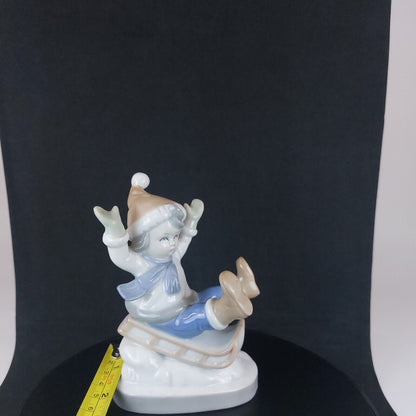 Vintage Germany-Made Porcelain Kid on Sled Figurine, Good Condition, 12cm